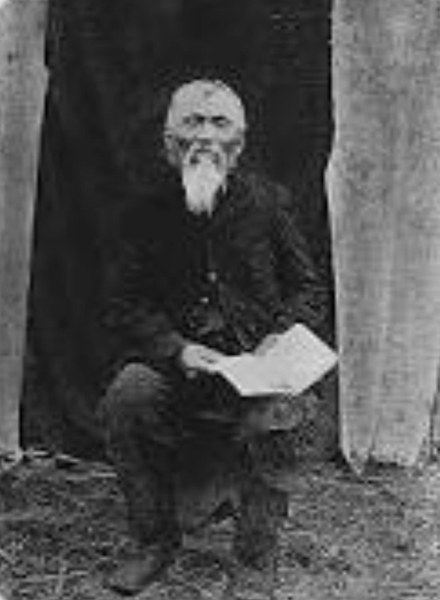 Arthur Wellington Clah, Tsimshian diarist, seated with his journal.