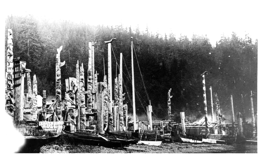 Northwest Coast village — totem poles and war canoes
